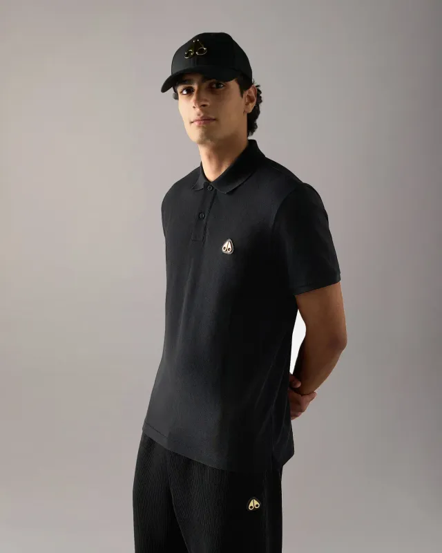 Moose Knuckles Gold Series Everett polo noir détails dorés